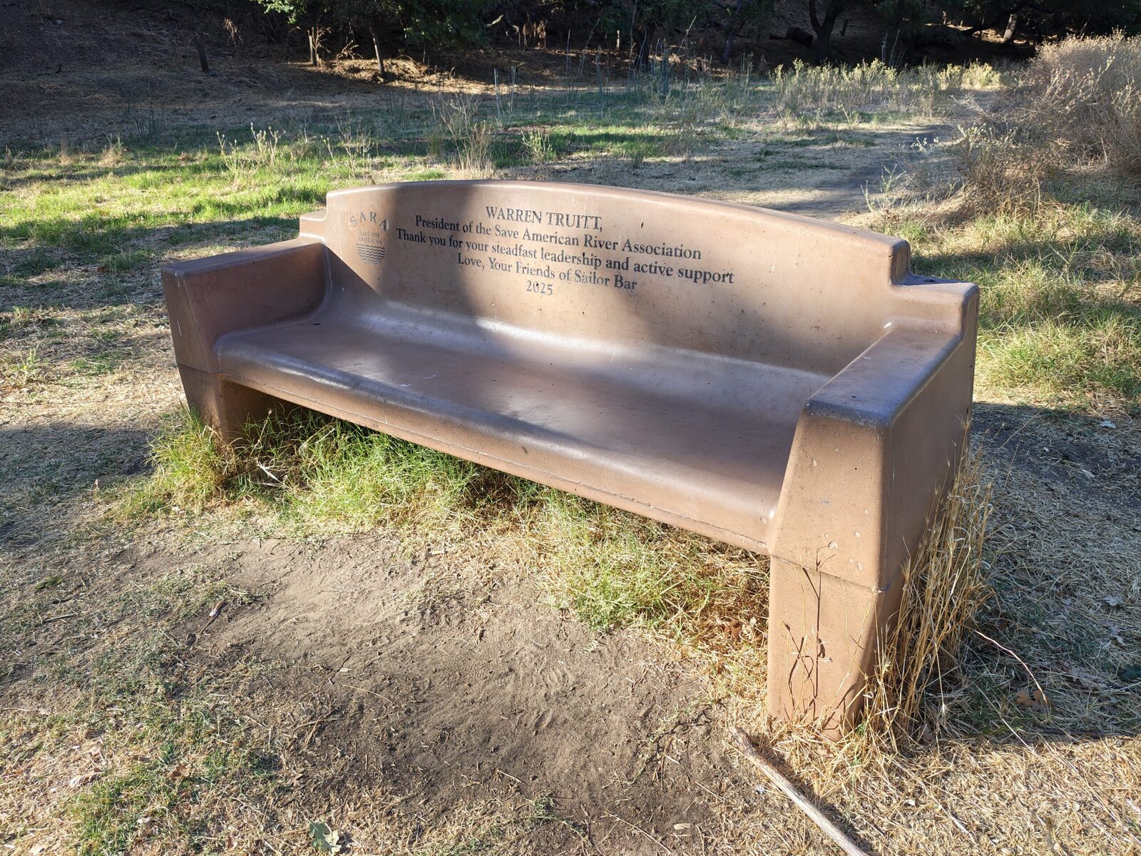 A bench in the dry grass meadow